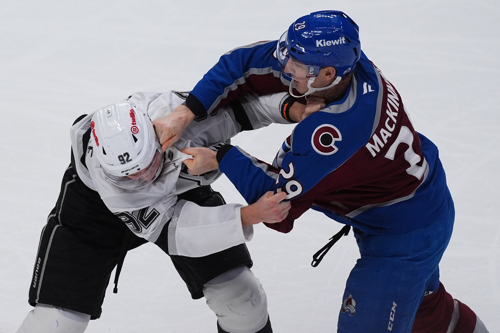 Colorado Avalanche center Nathan MacKinnon, right, punches Los Angeles Kings defenseman Brandt Clarke as they fight in the third period of an NHL hockey game Wednesday, Sept. 30, 2026, in Denver. (AP Photo/David Zalubowski)