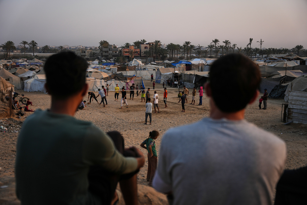 Young Palestinians play volleyball at a tent camp for displaced people in Zawayda, in the central Gaza Strip, Tuesday, Nov. 4, 2025.(AP Photo/Abdel Kareem Hana)