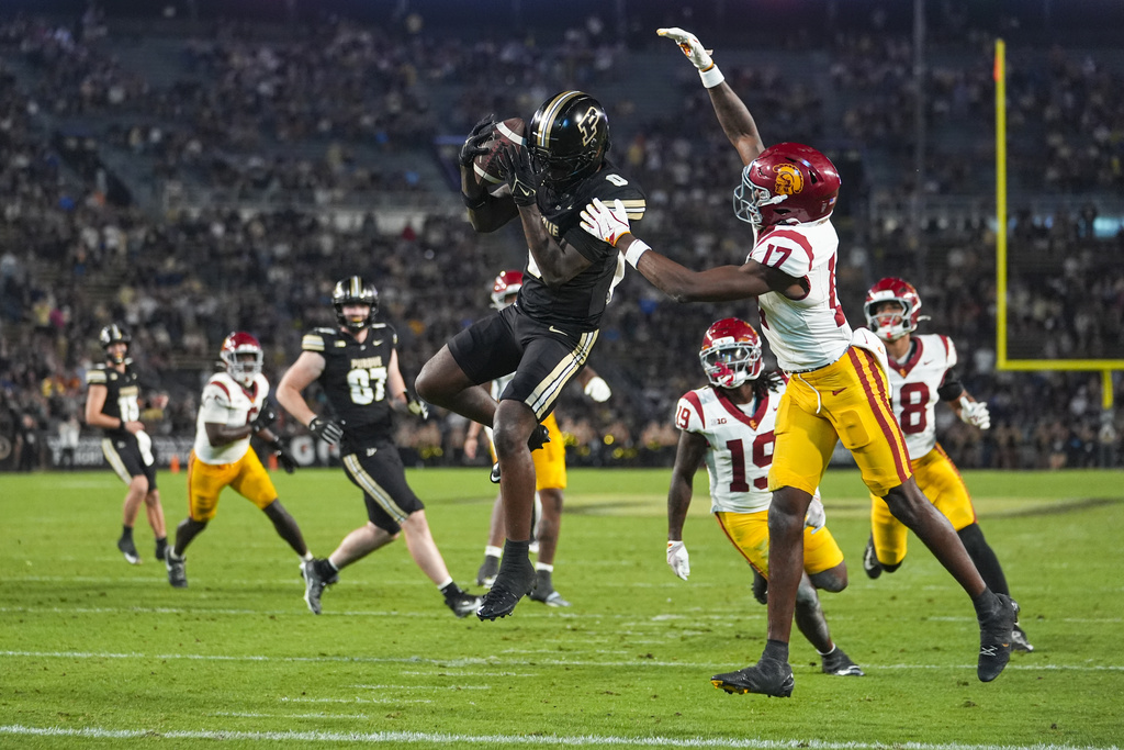 Purdue wide receiver Nitro Tuggle (0) makes a catch for a touchdown in front of Southern California cornerback DeCarlos Nicholson (17) during the second half of an NCAA college football game in West Lafayette, Ind., Saturday, Sept. 13, 2025. (AP Photo/Michael Conroy)