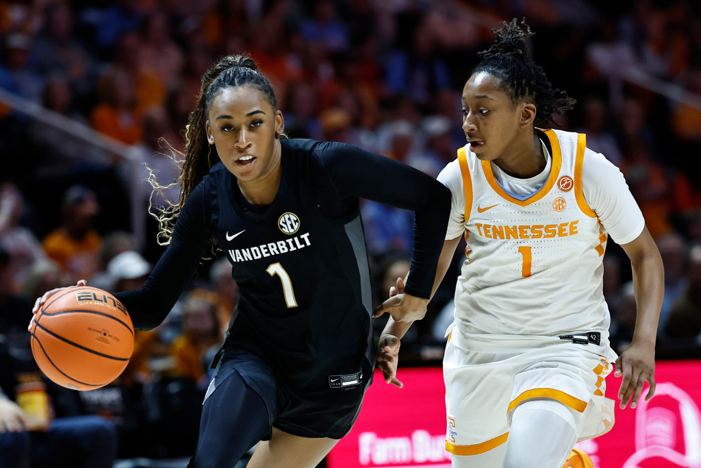 Vanderbilt guard Mikayla Blakes (1) drives against Tennessee guard Nya Robertson (1) during the second half of an NCAA college basketball game in Knoxville, Tenn, Sunday, March 1, 2026. (AP Photo/Wade Payne)