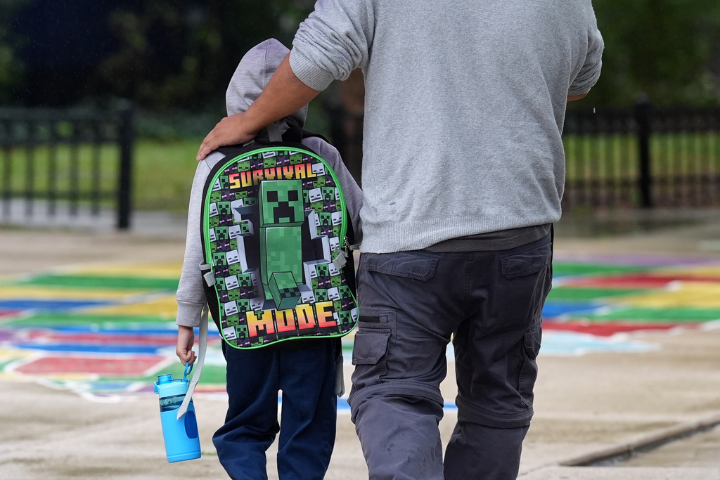 A Funston Elementary School student wears a Minecraft Survival Mode backpack as he arrives for school in Chicago's Logan Square neighborhood, Wednesday, Oct. 15, 2025. (AP Photo/Rebecca Blackwell)