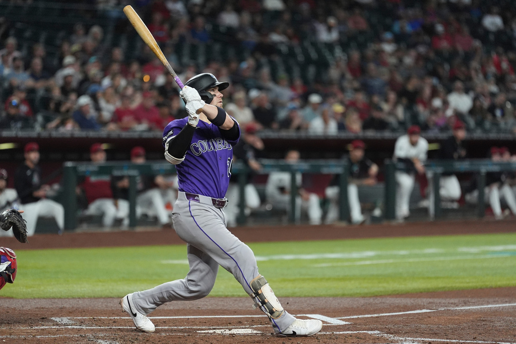 Colorado Rockies' Brett Sullivan watches the flight of his three-run home run against the Arizona Diamondbacks during the second inning of a baseball game, Wednesday, Aug. 12, 2026, in Phoenix. (AP Photo/Ross D. Franklin)