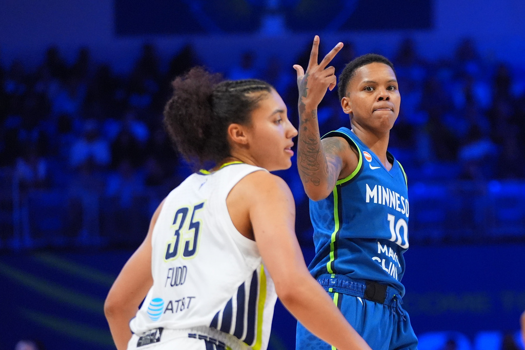 Minnesota Lynx guard Courtney Williams (10) gestures after scoring a three-pointer as Dallas Wings guard Azzi Fudd (35) looks on during the second half of a WNBA basketball game in Arlington, Texas, Thursday, May 14, 2026. (AP Photo/LM Otero)