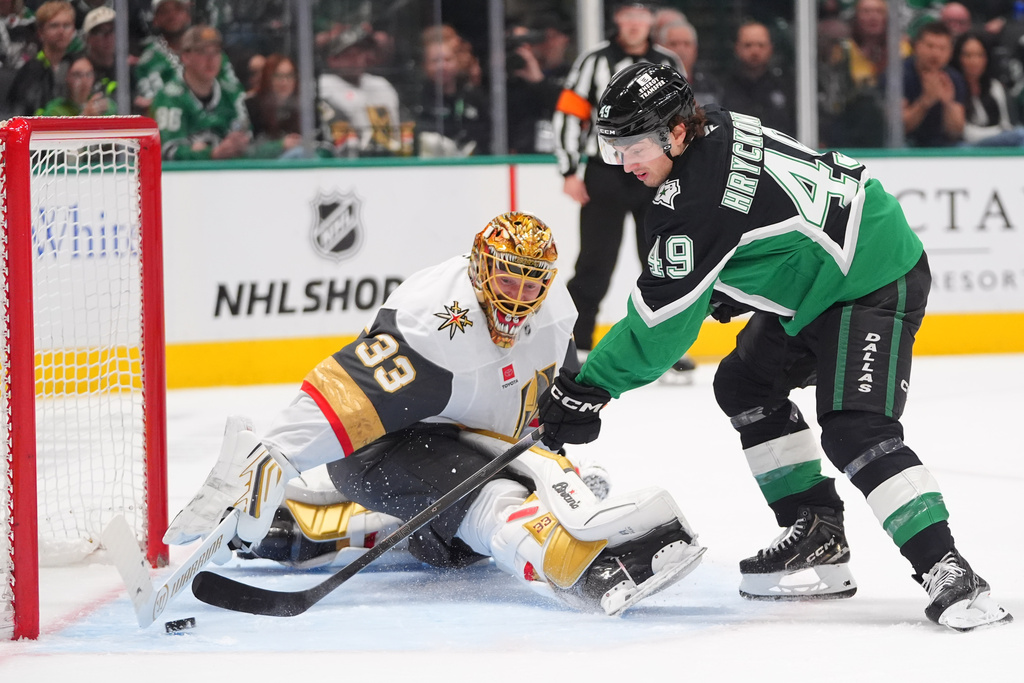 Dallas Stars center Justin Hryckowian (49) scores a goal against Vegas Golden Knights goaltender Adin Hill (33) during the first period of an NHL hockey game Sunday, March 22, 2026, in Dallas. (AP Photo/LM Otero)