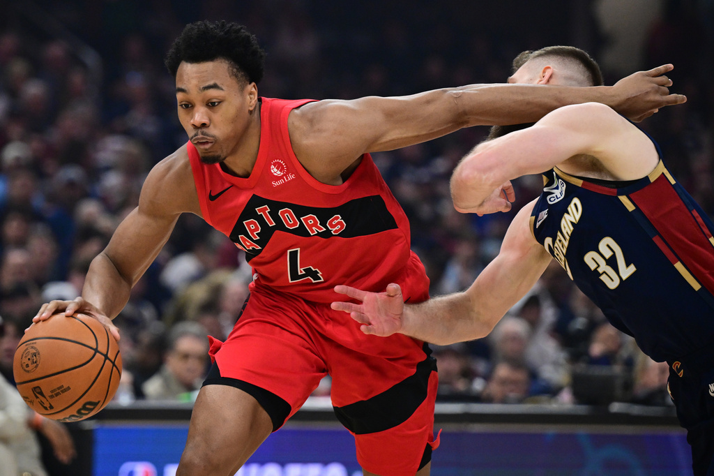Toronto Raptors forward Scottie Barnes drives on Cleveland Cavaliers forward Dean Wade during the first half in Game 1 of a first-round NBA playoffs basketball series, Saturday, April 18, 2026, In Cleveland. (AP Photo/David Dermer)