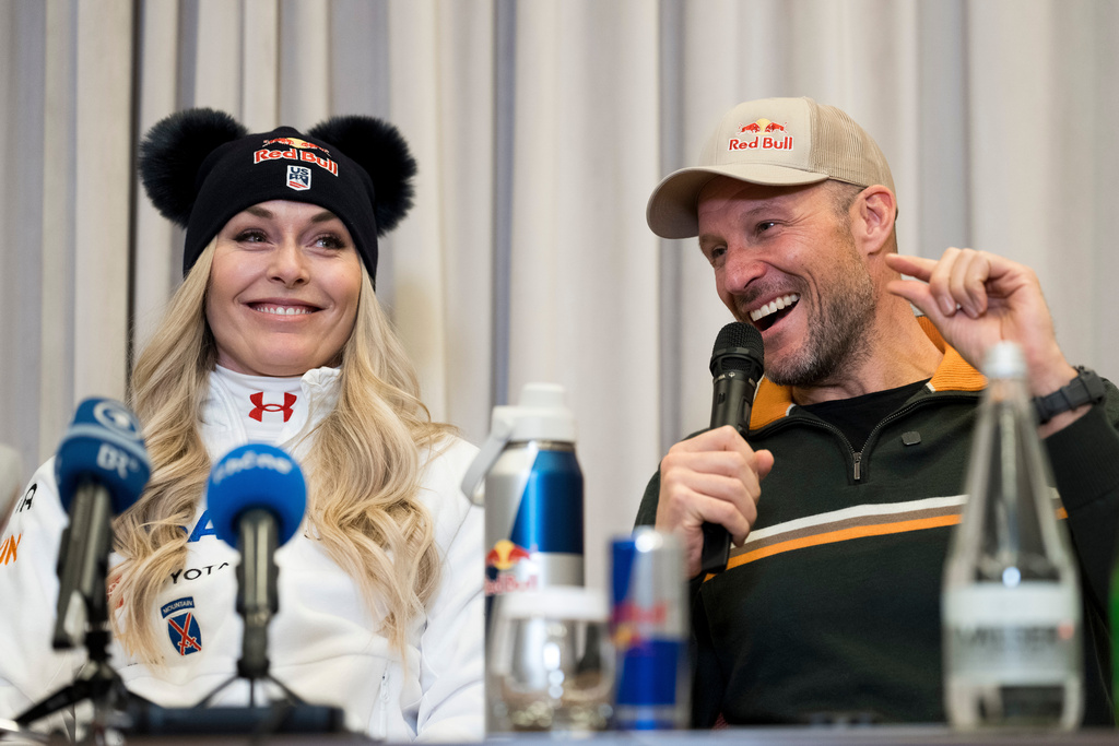 Coach and former Norwegian skier Aksel Lund Svindal, right, speaks with Lindsey Vonn, of the United States, during a press conference ahead of the women's World Cup downhill race Wednesday, Dec. 10, 2025 at the hotel Kempinski in St. Moritz, Switzerland. (Claudio Thoma/Keystone via AP)