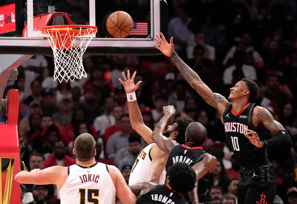Houston Rockets forwards Jabari Smith Jr. (10) and Kevin Durant, center, try to defend the basket against Denver Nuggets guard Jamal Murray, back, during the second half of an NBA Cup basketball game, Friday, Nov. 21, 2025, in Houston. (AP Photo/Karen Warren)