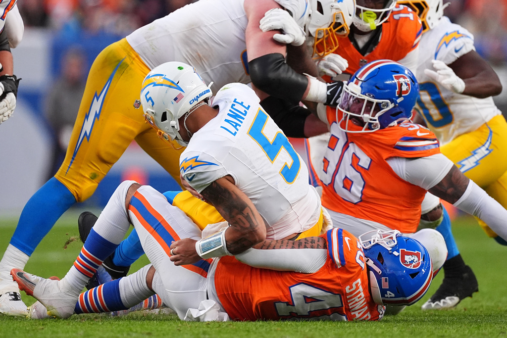 Denver Broncos linebacker Justin Strnad (40) sacks Los Angeles Chargers quarterback Trey Lance (5) during the second half of an NFL football game Sunday, Jan. 4, 2026, in Denver. (AP Photo/David Zalubowski)