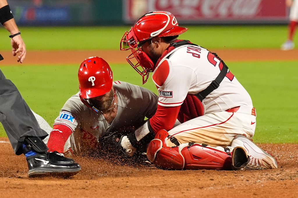 Philadelphia Phillies' Bryce Harper, left, is tagged out by Los Angeles Angels catcher Travis D'Arnaud as he tries to steal home during the eighth inning of a baseball game Saturday, Aug. 29, 2026, in Anaheim, Calif. (AP Photo/Mark J. Terrill)