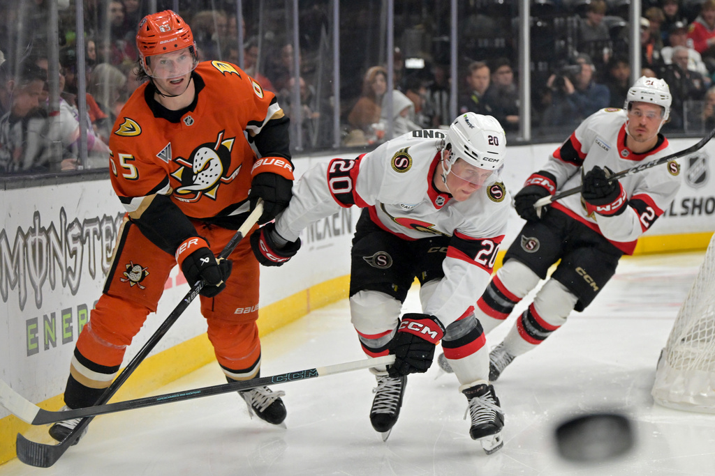Anaheim Ducks defenseman Jacob Trouba, left, passes the puck away from Ottawa Senators left wing Fabian Zetterlund (20) during the second period of an NHL hockey game Thursday, Nov. 20, 2025, in Anaheim, Calif. (AP Photo/Jayne Kamin-Oncea)