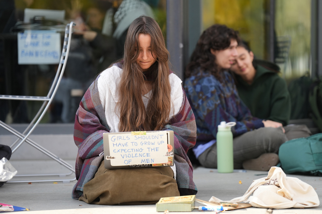 Student Isabel Breslin works on her laptop during a sit-in protest at Cornell University, Wednesday, Oct. 7, 2026, in Ithaca, N.Y. (AP Photo/Matt Burkhartt)