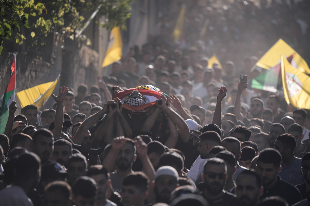 Mourners carry the body of Palestinian Imad Haroun Ishtayeh, 26, who was shot and killed by Israeli forces on Sunday at a concrete barrier separating the occupied West Bank from Jerusalem, during his funeral in the village of Salem, east of Nablus, Sunday, May 31, 2026. (AP Photo/Majdi Mohammed)