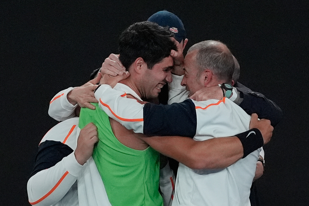 Carlos Alcaraz of Spain, left, celebrates with his team after defeating Novak Djokovic of Serbia in the men's singles final at the Australian Open tennis championship in Melbourne, Australia, Sunday, Feb. 1, 2026. (AP Photo/Asanka Brendon Ratnayake)