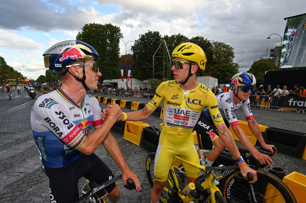Slovenia's Tadej Pogacar, wearing the overall leader's yellow jersey, celebrates with Belgium's Remco Evenepoel after the the last stage of the Tour de France cycling race in Paris, Sunday, July 26, 2026. (AP Photo/Dario Belingheri/Pool Photo via AP)
