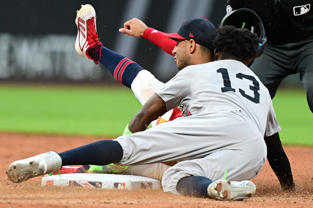 New York Yankees' Jazz Chisholm Jr. collides with Cleveland Guardians shortstop Brayan Rocchio after being tagged out at second base attempting to steal during the sixth inning of a baseball game, Monday, June 8, 2026, in Cleveland. (AP Photo/David Dermer)