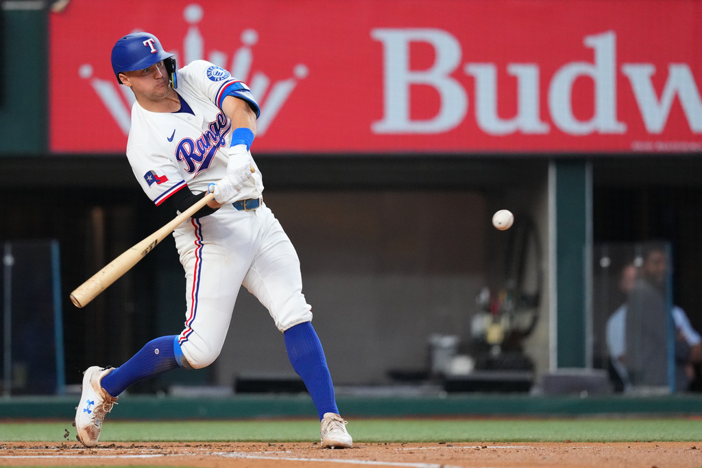 Texas Rangers' Josh Jung swings at a pitch before hitting a two-run home run against the New York Mets during the first inning of a baseball game Thursday, Sept. 24, 2026, in Arlington, Texas. (AP Photo/Julio Cortez)