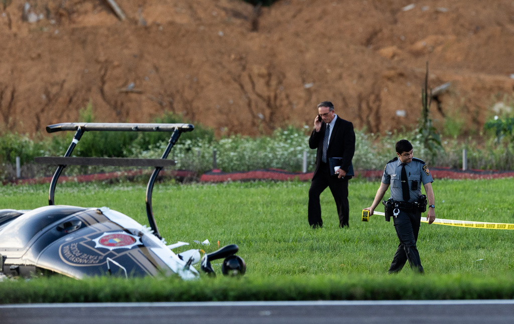 Authorities investigate a crash between a Pennsylvania State Police helicopter and a small plane at the Carlisle airport in Carlisle, Pa. Wednesday, Aug. 19, 2026. (Sean Simmers/The Patriot-News via AP)