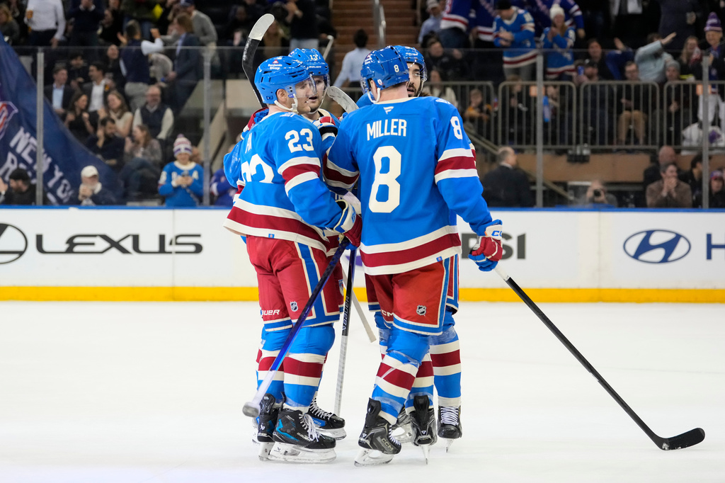 New York Rangers left wing Alexis Lafrenière (13) celebrates with teammates after scoring during the first period of an NHL hockey game against Buffalo Sabres, Wednesday, April 8, 2026, in New York. (AP Photo/Yuki Iwamura)