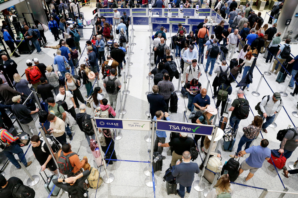 Air travelers progress through the long lines for the TSA security checkpoint in Terminal C at the George Bush Intercontinental Airport, Monday, March 23, 2026, in Houston. (AP Photo/Michael Wyke)