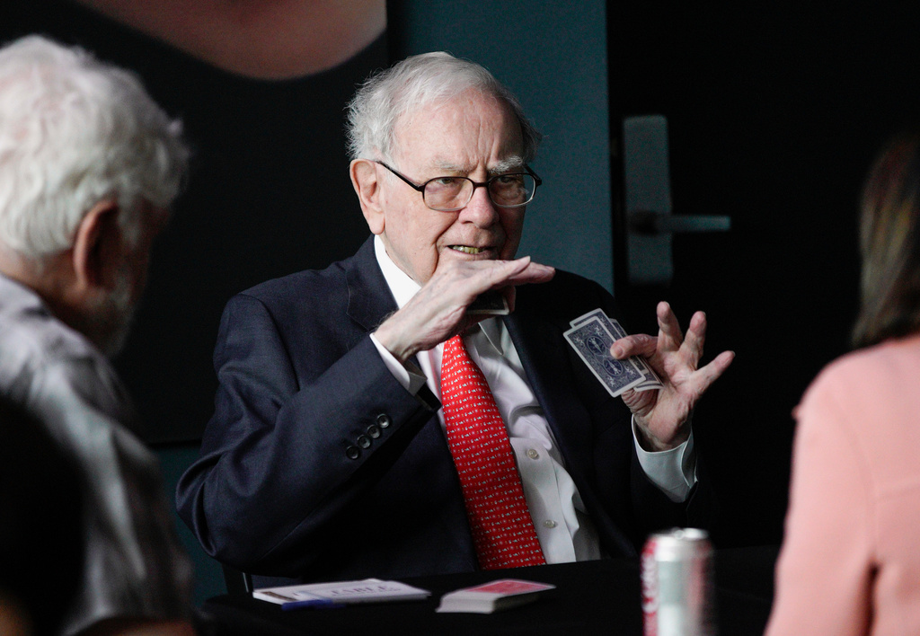 FILE - Warren Buffett, chairman and CEO of Berkshire Hathaway, gestures as he plays bridge outside Berkshire-owned Borsheims jewelry store in Omaha, Neb., Sunday, May 6, 2018. (AP Photo/Nati Harnik, File)