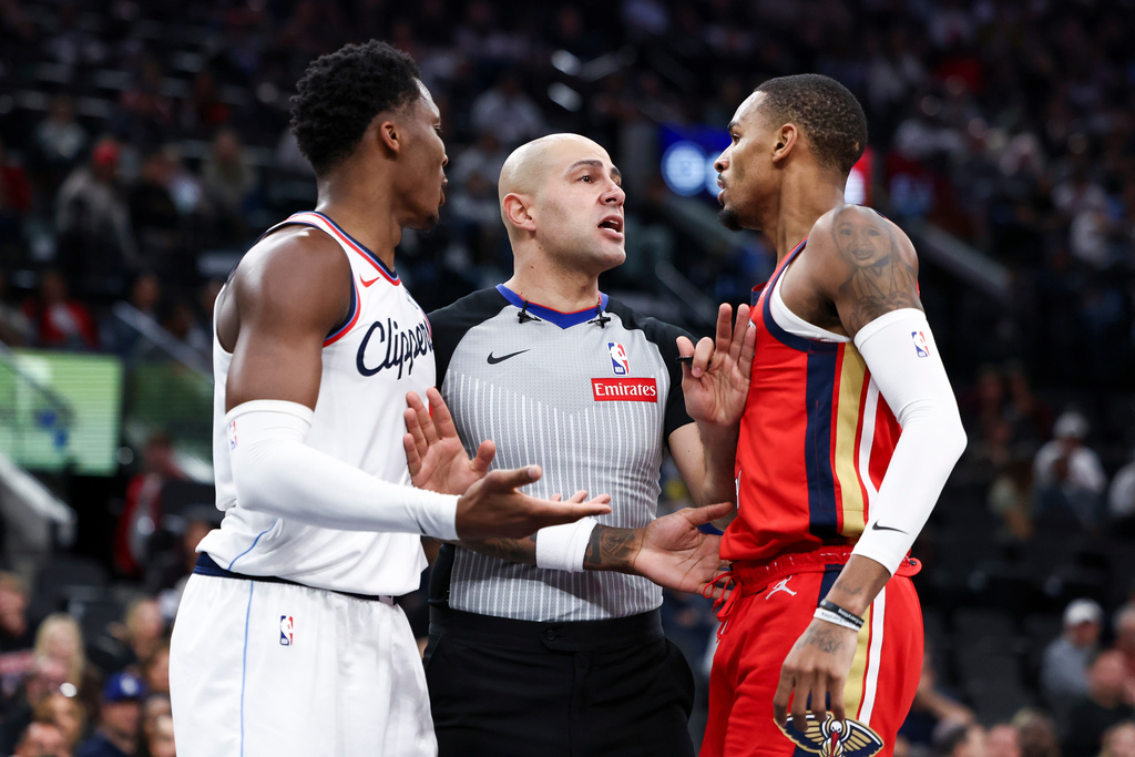 Los Angeles Clippers guard Bennedict Mathurin, left, and New Orleans Pelicans guard Dejounte Murray, right, react towards the referee, center, after a play during the first half of an NBA basketball game, Sunday, March 1, 2026, in Inglewood, Calif. (AP Photo/Jessie Alcheh)