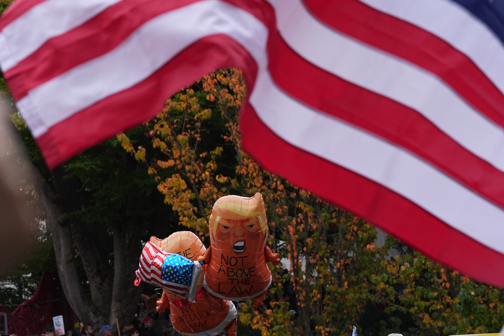 People take part in a "No Kings" protest Saturday, Oct. 18, 2025, in Seattle. (AP Photo/Lindsey Wasson)