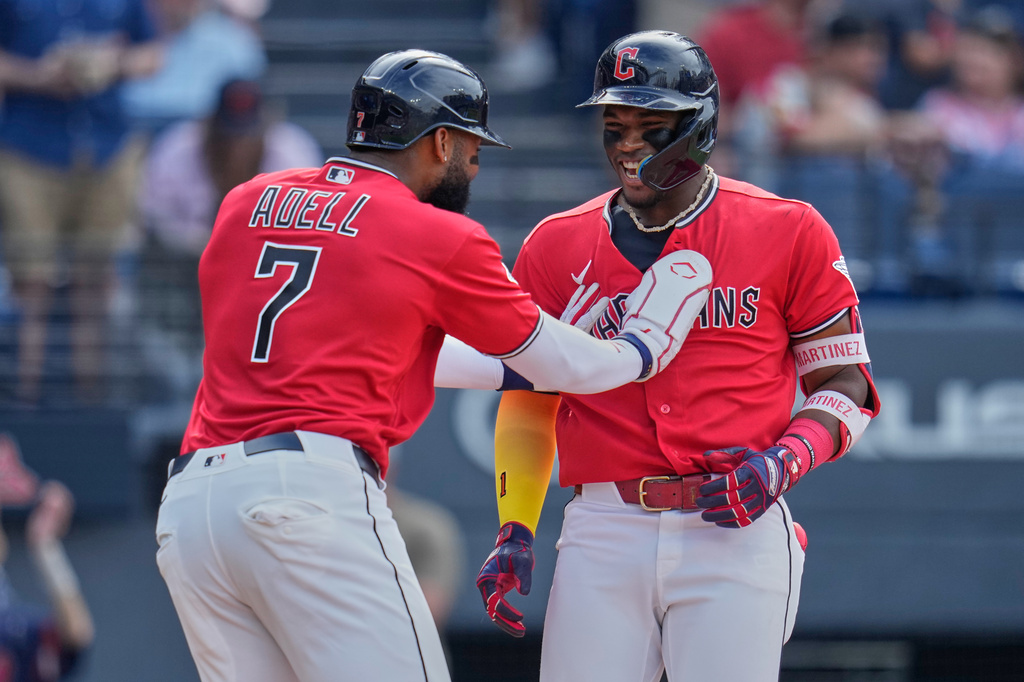 Cleveland Guardians' Angel Martínez (1) celebrates with Jo Adell (7) after hitting a two-run home run in the second inning of a baseball game against the Kansas City Royals in Cleveland, Saturday, Aug. 29, 2026. (AP Photo/Sue Ogrocki)