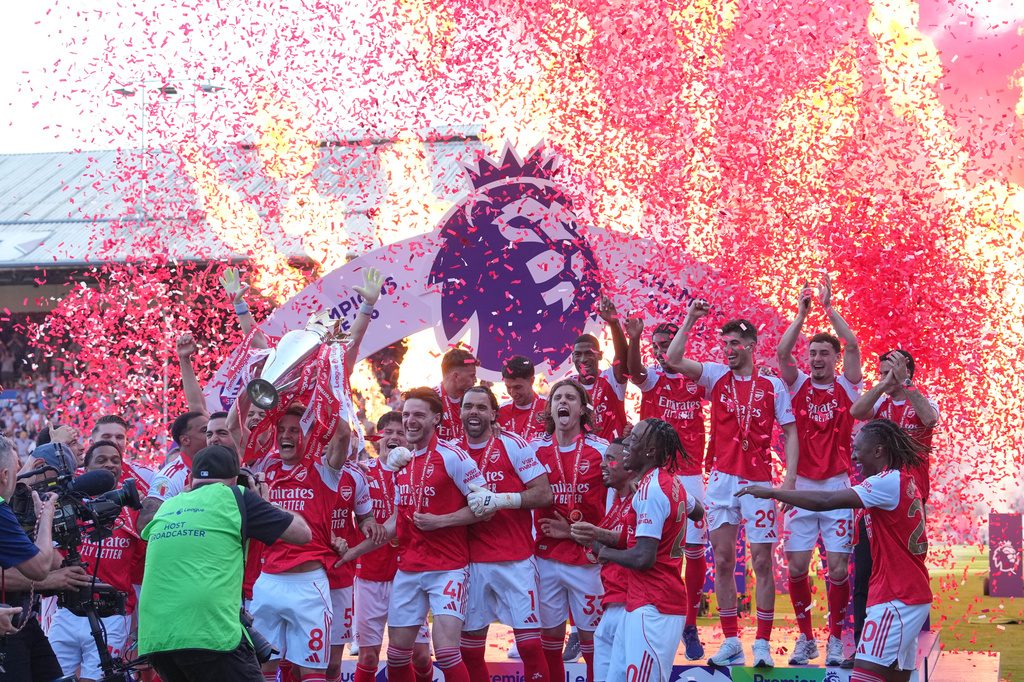 Arsenal players celebrate their Premier League title with the trophy after the English Premier League soccer match between Crystal Palace and Arsenal in London, England, Sunday, May 24, 2026. (AP Photo/Kin Cheung)