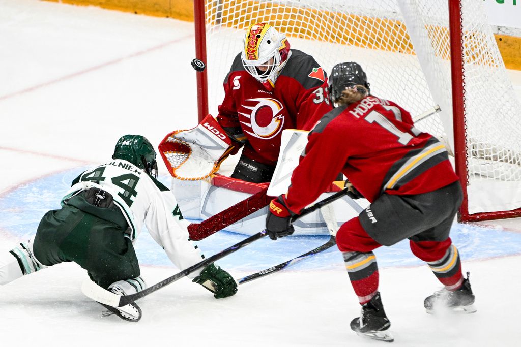 Ottawa Charge's goaltender Gwyneth Philips (33) blocks a shot from Boston Fleet's Jill Saulnier (44) during the third period of an PWHL hockey game in Ottawa, Saturday, Feb. 28, 2026. (Spencer Colby/The Canadian Press via AP)