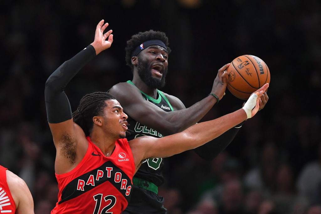 Toronto Raptors forward Collin Murray-Boyles, left, and Boston Celtics center Neemias Queta vie for control of the ball in the first half of an NBA basketball game, Sunday, April 5, 2026, in Boston. (AP Photo/Steven Senne)