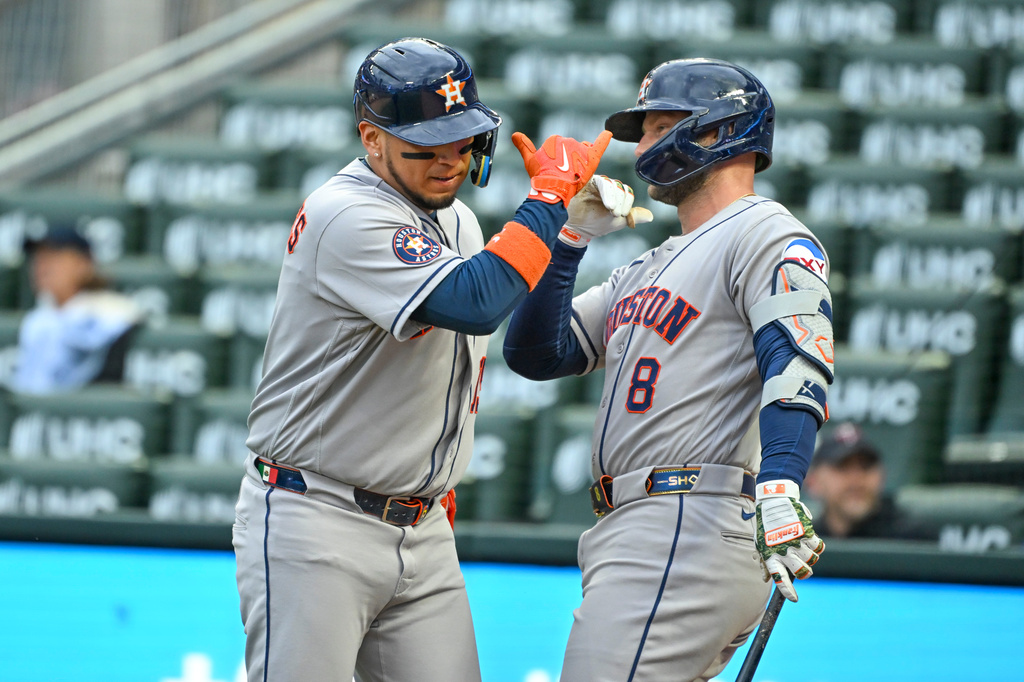 Houston Astros' Isaac Paredes, left, celebrates with Christian Walker (8) after hitting a two-run home run that also scored Jeremy Peña against the Minnesota Twins during the first inning of a baseball game Tuesday, May 19, 2026, in Minneapolis. (AP Photo/Craig Lassig)