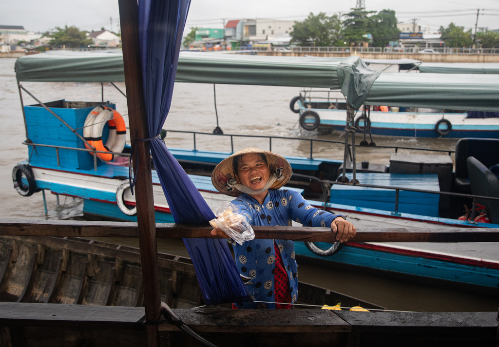A vendor offers jackfruit slices to tourists visiting a floating market in Can Tho, Vietnam on June 22, 2024. (AP Photo/Anton L. Delgado)