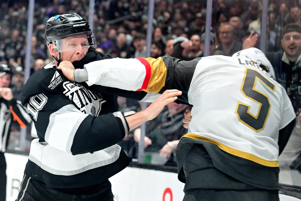 Los Angeles Kings right wing Corey Perry (10) and Vegas Golden Knights defenseman Jeremy Lauzon (5) fight in the second period of an NHL hockey game Wednesday, Feb. 25, 2026, in Los Angeles. (AP Photo/Wally Skalij)