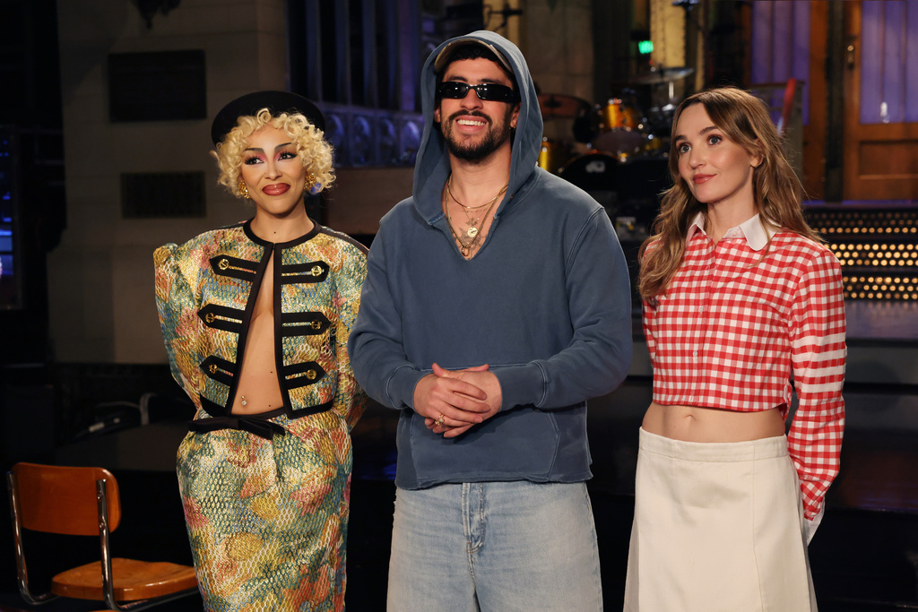 This image released by NBC shows host Bad Bunny, center, with musical guest Doja Cat, left, and cast member Chloe Fineman during the taping of promotional spots for the upcoming "Saturday Night Live" on Thursday, Oct. 2, 2025. (Rosalind O'Connor/NBC via AP)
