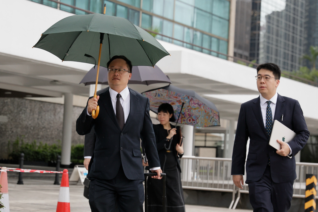 Jenkin Suen, counsel for the Hong Kong government, arrives for the closing submissions at the Independent Commission investigation hearing into last year's Tai Po deadly fire, in Hong Kong, Friday, July 17, 2026. (AP Photo/May James)