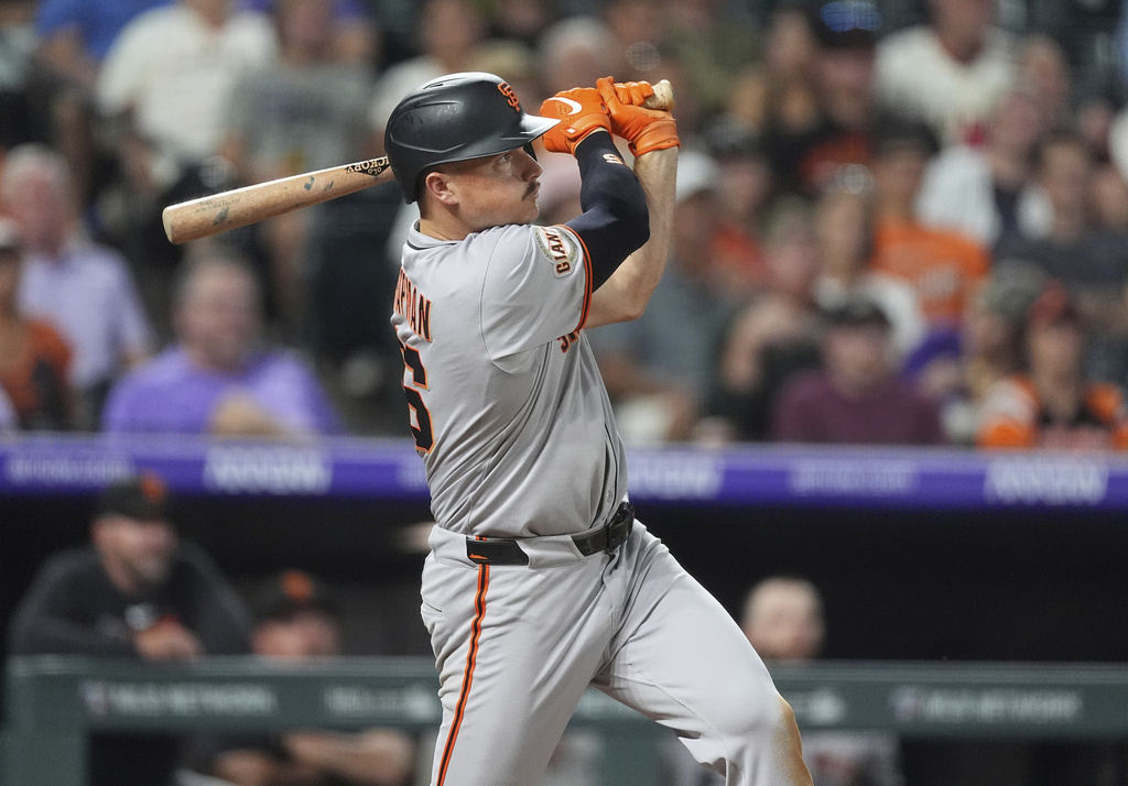 San Francisco Giants' Matt Chapman follows the flight of his three-run home run off Colorado Rockies relief pitcher Juan Mejia in the sixth inning of a baseball game Wednesday, Sept. 3, 2025, in Denver. (AP Photo/David Zalubowski)