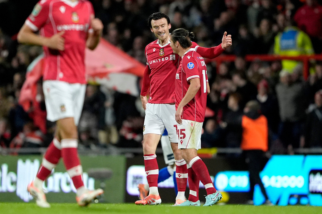 Wrexham's Kieffer Moore, 2nd right, celebrates scoring during the English League Cup fourth round soccer match between Wrexham and Cardiff City in Wrexham, Wales, Tuesday Oct. 28, 2025. (Peter Byrne/PA via AP)