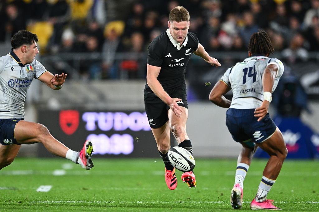 New Zealand's Jordie Barrett kicks the ball past defenders during the Nations Championship rugby international between the All Blacks and Italy in Wellington, New Zealand, Saturday, July 11, 2026. (Kerry Marshall/Photosport via AP)
