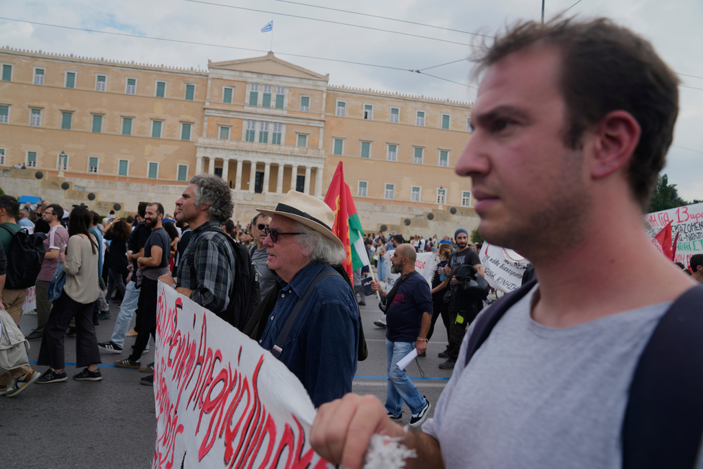 Protesters take part in a nationwide 24-hour strike in Athens, Greece, Tuesday, Oct. 14, 2025, as labor unions demand higher wages and the withdrawal of a bill changing work hours. (AP Photo/Petros Giannakouris)