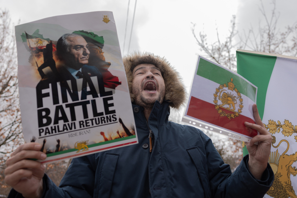 Iranian people attend a demonstration in support of the U.S. and Israeli strikes on Iran in front of Iranian Embassy in Yerevan, Armenia, Saturday, Feb. 28, 2026. (AP Photo/Anthony Pizzoferrato)