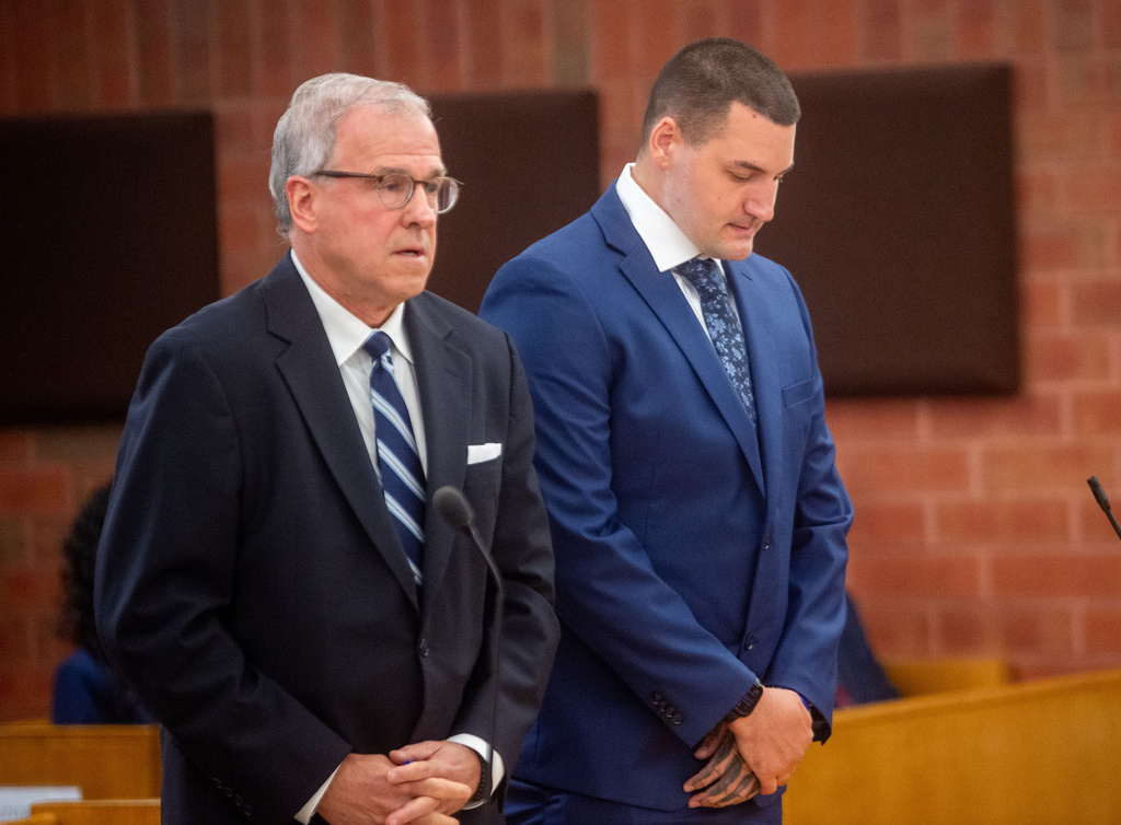 Former Hartford police officer Joseph Magnanom, right, stands with his attorney, Patrick Tomasiewicz, during his arraignment at Hartford Superior Court in Hartford, Conn., on Friday, June 5, 2026. (Aaron Flaum/Hartford Courant via AP, Pool)