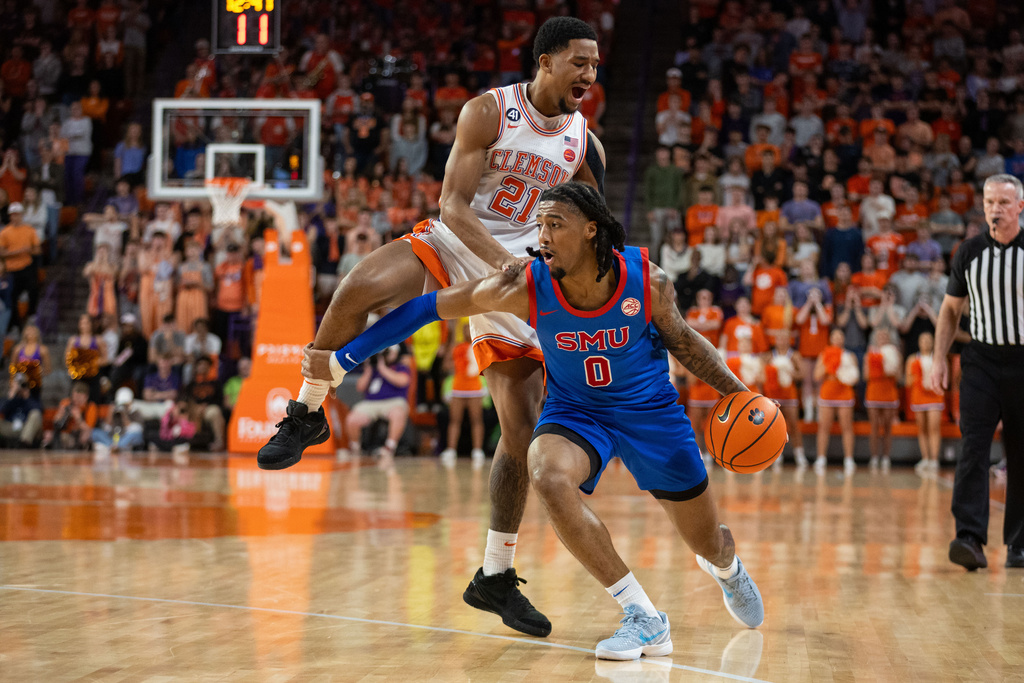 SMU guard B.J. Edwards (0) drives past Clemson guard Ace Buckner (21) during the first half of an NCAA college basketball game Wednesday, Jan. 7, 2026, in Clemson, S.C. (AP Photo/Scott Kinser)
