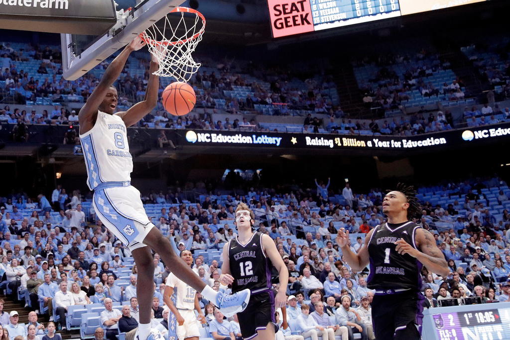 North Carolina forward Caleb Wilson (8) dunks against Central Arkansas guard Ty Robinson (12) and guard Camren Hunter (1) during the first half of an NCAA college basketball game Monday, Nov. 3, 2025, in Chapel Hill, N.C. (AP Photo/Chris Seward)