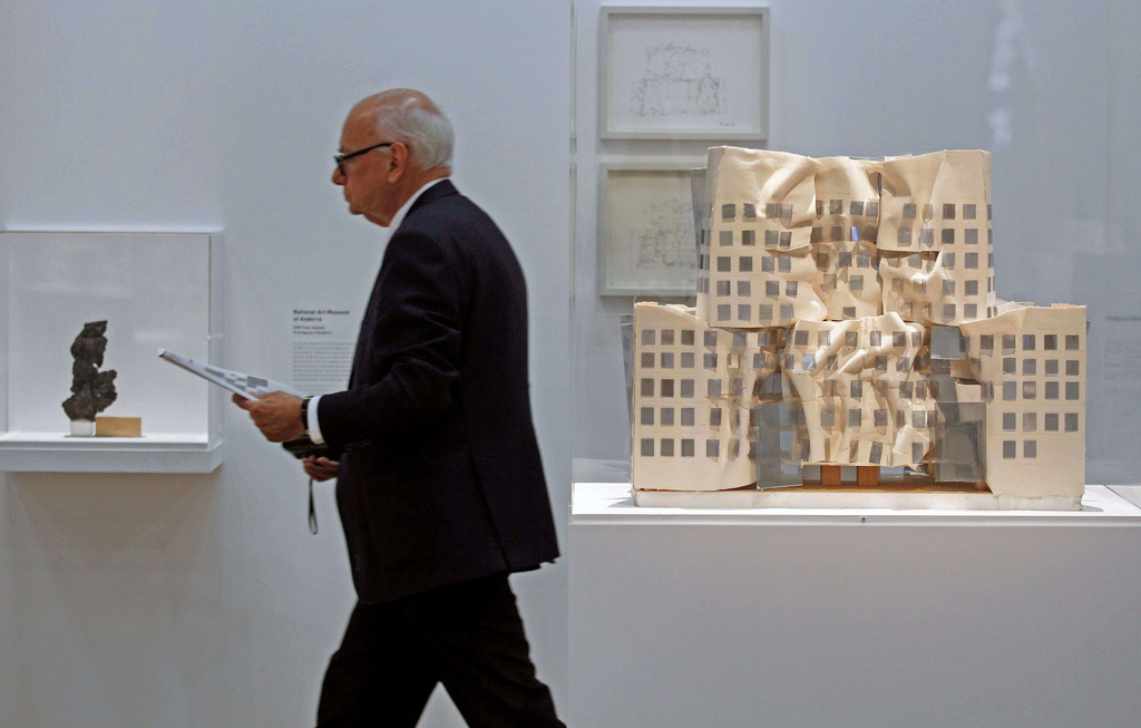 FILE - A model of Frank Gehry's Dr. Chau Chak Wing building, right, built in Sydney, Australia, is presented at the Pompidou Center in Paris, Oct. 6, 2014, as part of a retrospective on American-Canadian architect Frank Gehry. (AP Photo/Remy de la Mauviniere, File)