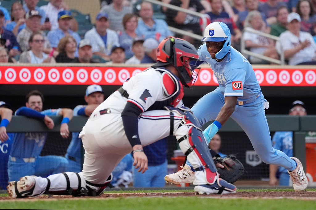 Kansas City Royals' Tyler Tolbert, right, scores on a double by Carter Jensen as Minnesota Twins catcher Ryan Jeffers (27) awaits the throw in the fifth inning of a baseball game Wednesday, July 29, 2026, in Minneapolis. (AP Photo/Bruce Kluckhohn)
