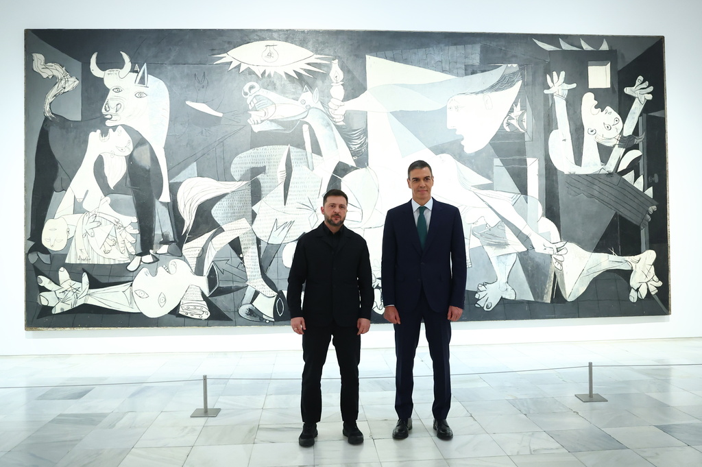In this photo provided by the Spanish government, Ukrainian President Volodymyr Zelenskyy poses with Spain's Prime Minister Pedro Sánchez in front of Pablo Picasso's "Guernica" in Madrid Tuesday, Nov. 18, 2025. (Spanish government via AP)
