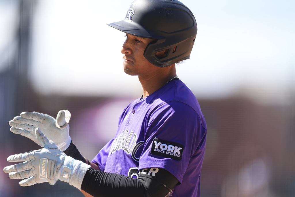 Colorado Rockies' Ryan Ritter reacts after singling to drive in two runs off Arizona Diamondbacks relief pitcher Jake Woodford in the seventh inning of a baseball game, Sunday, Aug. 17, 2025, in Denver. (AP Photo/David Zalubowski)
