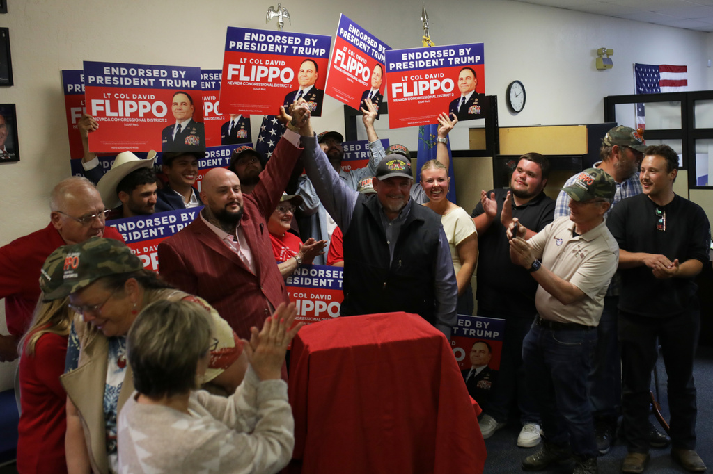 David Flippo, a Republican candidate for Congress in Nevada's 2nd district, center right, cheers with supporters during a primary election night watch party Tuesday, June 9, 2026, in Reno, Nev. (AP Photo/William Hale Irwin)