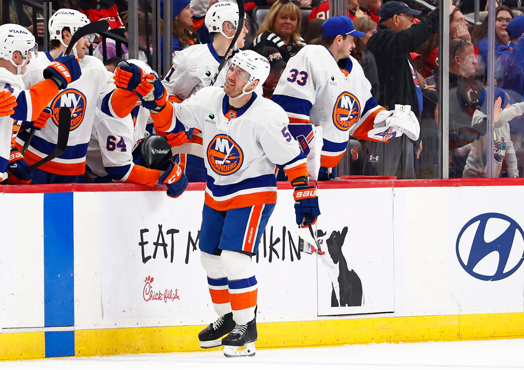 New York Islanders center Casey Cizikas (53) celebrates with teammates after scoring a goal against the New Jersey Devils during the second period of an NHL hockey game, Thursday, Feb. 5, 2026, in Newark, N.J. (AP Photo/Noah K. Murray)