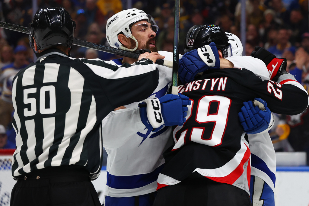 Tampa Bay Lightning left wing Nick Paul, second from left, is separated from Buffalo Sabres left wing Beck Malenstyn (29) during the first period of an NHL hockey game Monday, April 6, 2026, in Buffalo, N.Y. (AP Photo/Jeffrey T. Barnes)